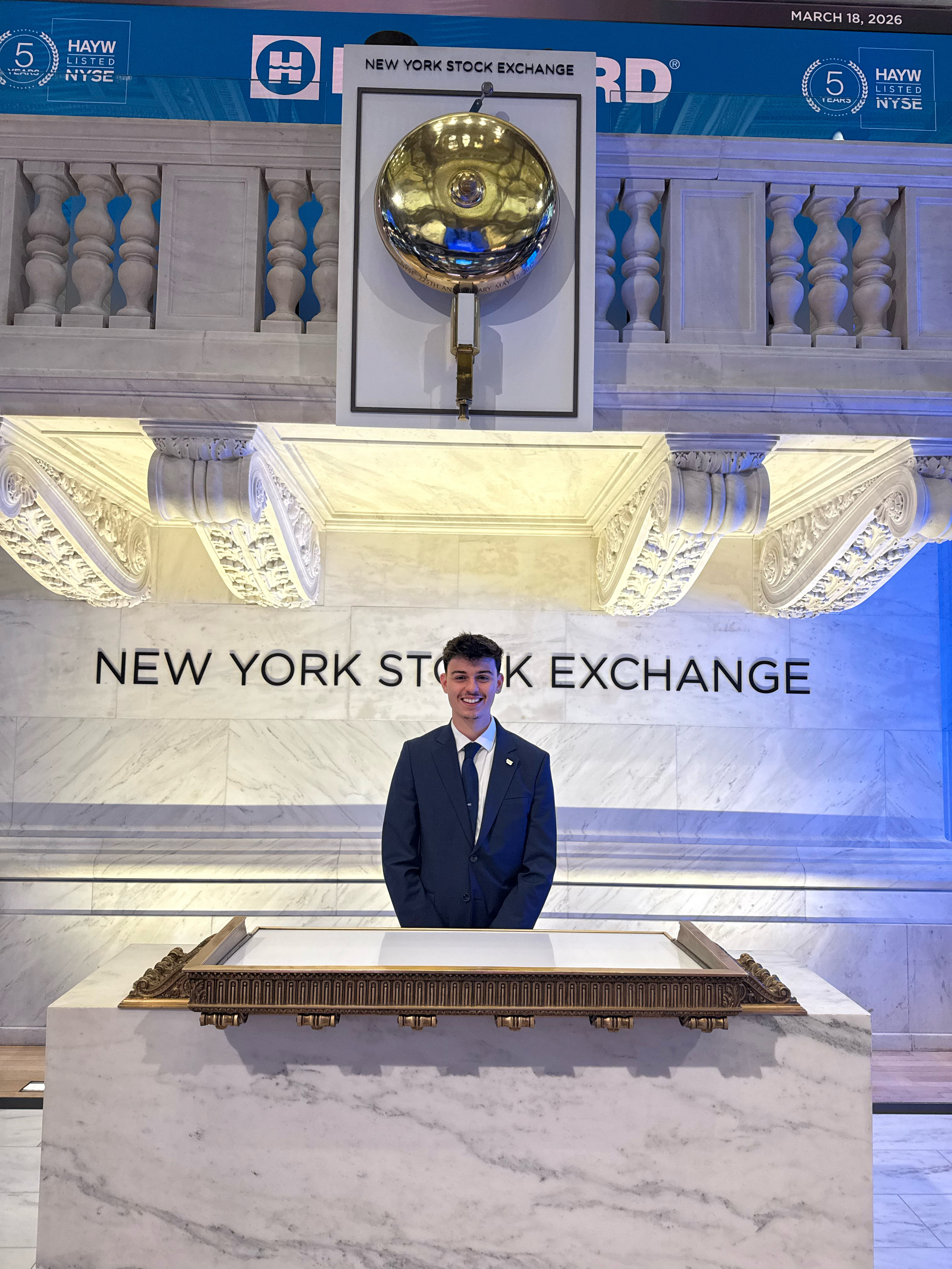 Dario Benes at the New York Stock Exchange bell podium